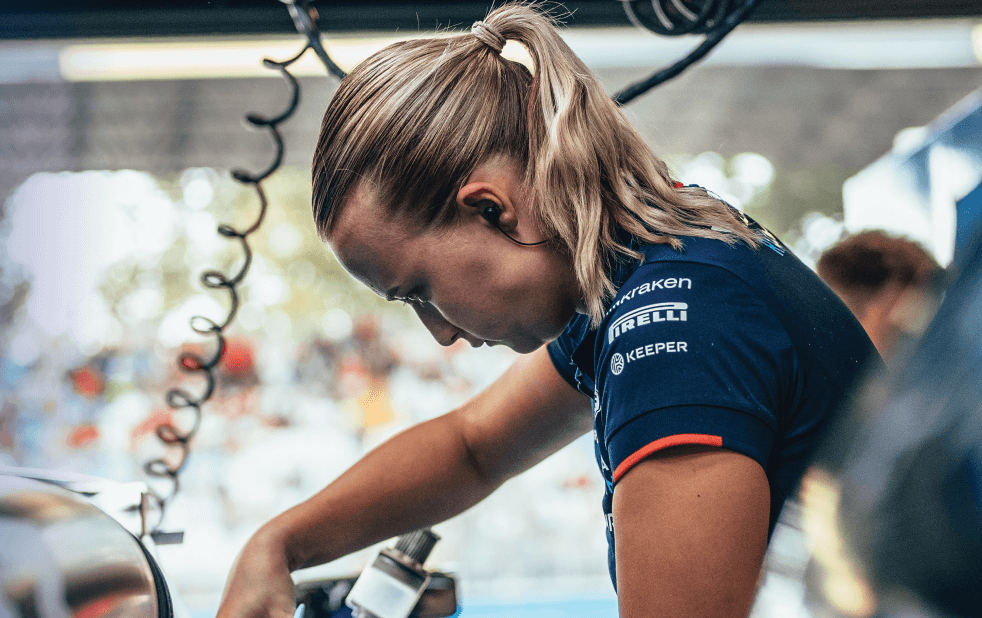 A female engineer working on a race car